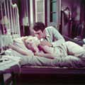 Marilyn Monroe is Cherie in this image from her classic 1956 movie Bus Stop. Here Marilyn is laying in bed, looking up at her co-star Don Murray, who has his arm on her shoulder. Milton H Greene took this on location color photograph.