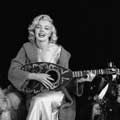 This fun, black and white photograph by Milton H Greene features Marilyn Monroe with a big smile and holding a mandolin. Taken in September, 1953 in Los Angeles for Look magazine, this was Milton and Marilyn's First Sitting.